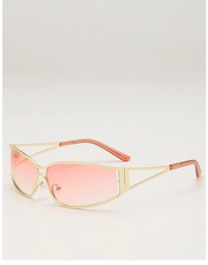 Detail of gold metal frames with hollow geometric temples and pink gradient lenses
