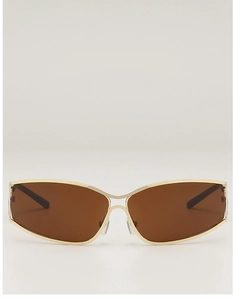 Close-up of retro futuristic gold metal cutout sunglasses with sleek brown lenses