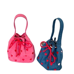 Pink canvas and blue denim drawstring bucket bags with red heart embroidery and handles