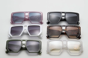Close-up of stylish oversized square sunglasses featuring unique hollow bridge and gradient lenses