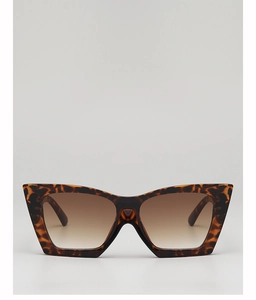 Close-up of retro cat-eye sunglasses featuring tortoiseshell frames and brown lenses