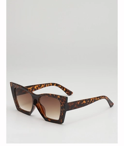 Detail of tortoise shell square sunglasses with gradient brown lenses and metal hinges