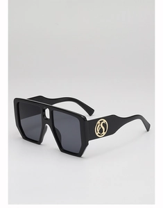 Close-up of square sunglasses temple featuring a luxury gold circular metal logo accent