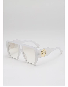 Detail view of translucent white square frame sunglasses with gold logo on temple