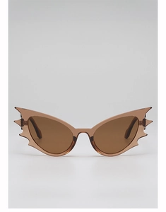 Close-up of translucent amber bat-wing sunglasses with serrated edges and brown lenses