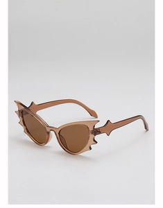 Detail of bat-shaped amber sunglasses featuring creative spiked temples and resin frame