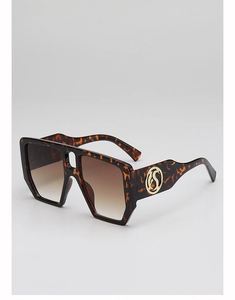 Close-up of tortoise shell square frames with gradient lenses and gold logo detail