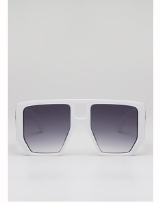 Detail of oversized white geometric sunglasses with grey gradient lenses and gold accents