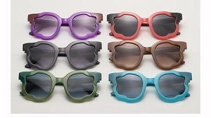 Detailed view of irregular wavy scalloped sunglasses in six trendy color variants