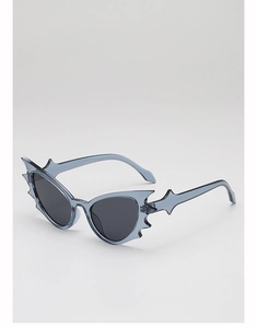 Detail of blue bat-shaped sunglasses with translucent frames and silver star accents