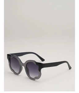 Detail of wavy petal frames with purple gradient lenses on oversized sunglasses