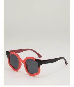 Close-up of irregular wave-shaped purple and black oversized fashion sunglasses