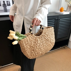 Handwoven straw hobo bag with unique circular wooden bead handle for women's daily use