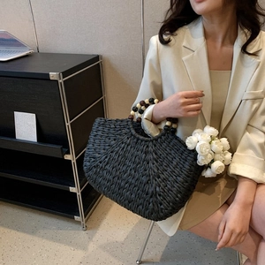 Black woven half-moon handbag with vintage multi-color beaded handle for elegant summer styling