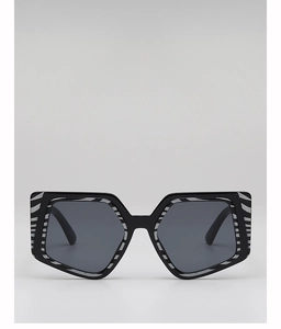 Detail of square oversized sunglasses with black frame and zebra print accents