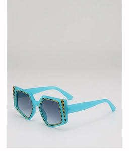Detail of square sunglasses featuring blue frames and yellow checkerboard patterned edges
