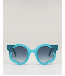 Detailed view of blue wavy petal-shaped sunglasses frame with gradient grey lenses