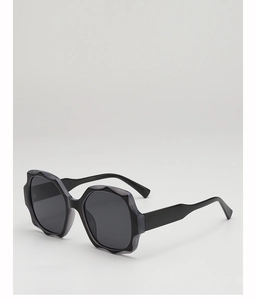 Detail of premium oversized black sunglasses featuring irregular wavy frame design