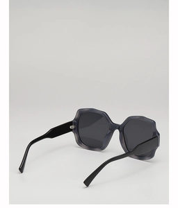 Detail view of stylish oversized geometric sunglasses with dark blue translucent frames