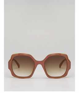 Detail of oversized hexagonal terracotta sunglasses with brown gradient lenses