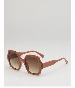 Detail of oversized sunglasses with brown wave-textured frame and gradient lenses