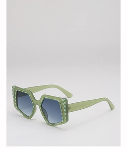 Detail view of square oversized sunglasses with green plaid pattern and gradient lenses
