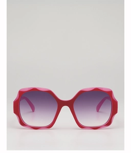 Close-up of pink oversized polygon sunglasses with gradient purple lenses for women