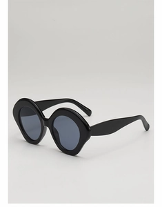 Detail of retro oversized black sunglasses with thick frames and gradient grey lenses