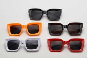 Flat lay of retro square sunglasses in black, orange, brown, white, and red frames