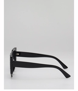 Side view of square oversized black sunglasses featuring wide temples and grain texture