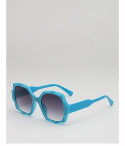 Close-up of bright blue wavy oversized sunglasses with gradient lenses and thick frame
