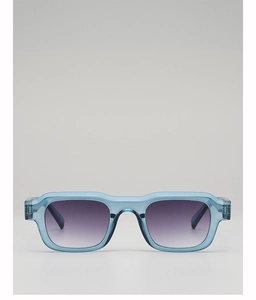 Detail of square light blue translucent sunglasses with gradient purple lenses