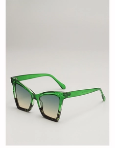 Close-up of translucent green cat-eye sunglasses with gradient lenses and temple detail