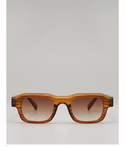 Close-up of translucent amber brown retro square sunglasses frame and gradient lenses