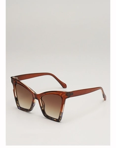 Detail of tortoiseshell cat eye sunglasses with brown gradient lenses and resin frame
