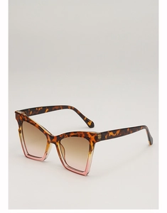 Detailed close-up of tortoise shell and pink cat-eye sunglasses with gradient lenses