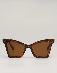 Macro shot of tortoiseshell cat-eye sunglasses with polished frame and brown tinted lenses