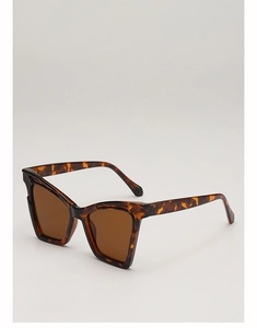 Detail of vintage cat-eye sunglasses with tortoise frame and brown lenses