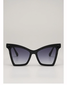 Detail of oversized black cat-eye sunglasses featuring stylish gray gradient lenses