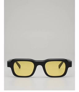 Front view of black square sunglasses featuring translucent yellow tinted lenses