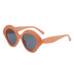 Fashionable peach orange wavy thick frame sunglasses with round grey lenses in a 45-degree view