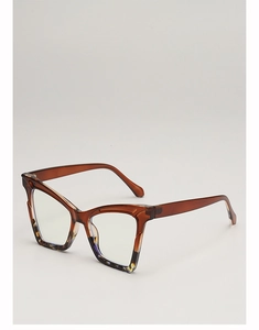 Detailed close-up of cat-eye glasses with amber tortoiseshell frame and clear lenses
