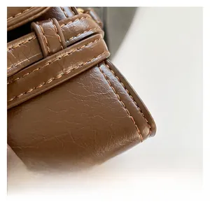 Macro shot of brown leather handbag texture with neat stitching and layered edge details