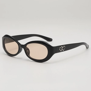 Lunettes de soleil ovales rétro, monture noire, verres ambrés et détails coeur en métal