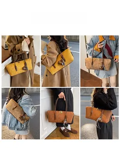 Detail view of suede Boston underarm bag with leather tassels and gold zipper in three colors