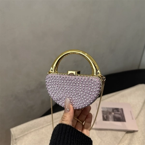 Sparkly purple rhinestone evening clutch with gold ring handle and metal chain strap