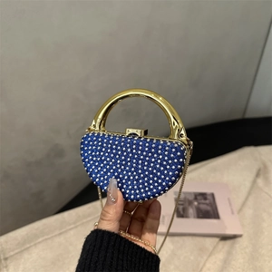 Sparkling blue rhinestone evening bag with gold semicircular handle and chain strap