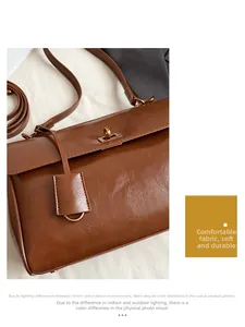 Macro detail of caramel brown leather texture with golden metallic lock on shoulder bag