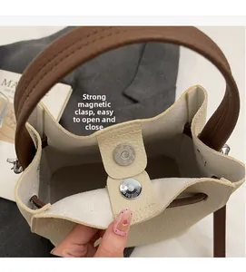 Détail de la fermeture magnétique puissante sur ce sac seau en cuir grainé