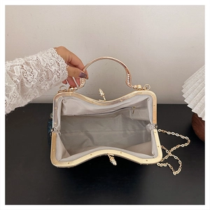 Detail view of the vintage evening bag interior with lining, zipper pocket, and gold frame